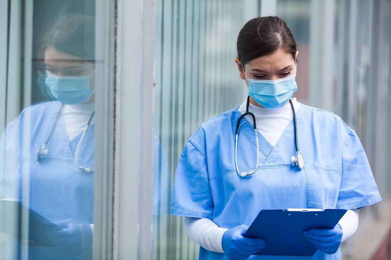 Triage nurse reviewing a patients file
