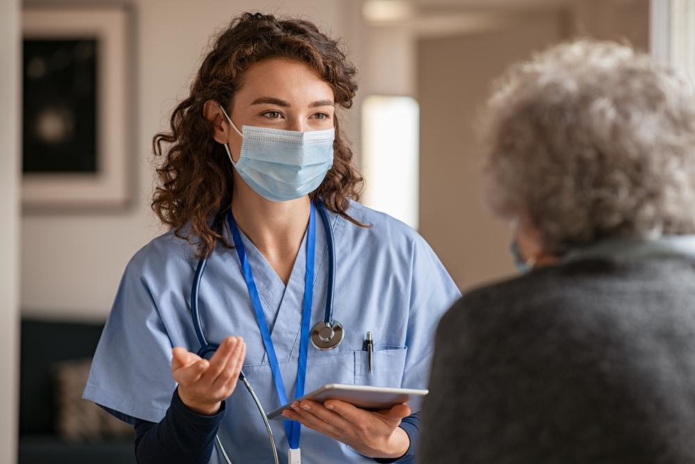 Nurse Practitioner with patient wearing a mask