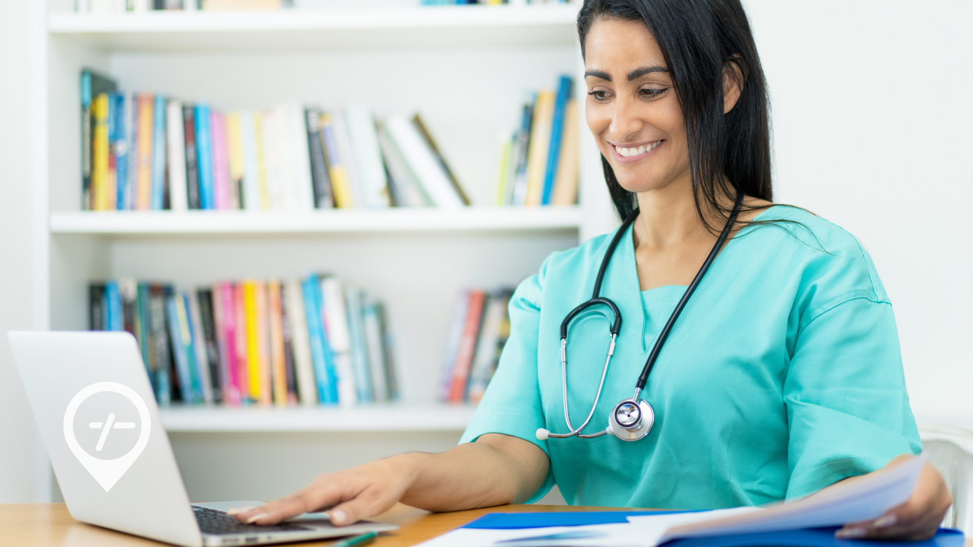 A nurse sitting at her office desk reviewing her employment taxes on her laptop.