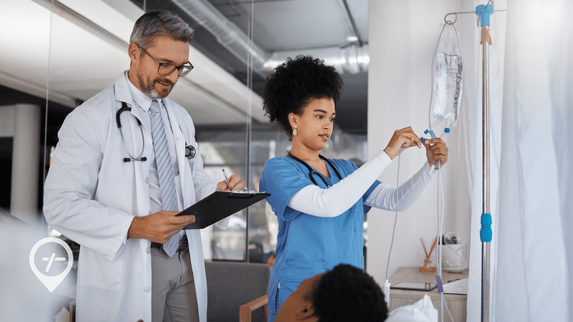 A doctor and nurse visiting a hospital patient during their rounds.