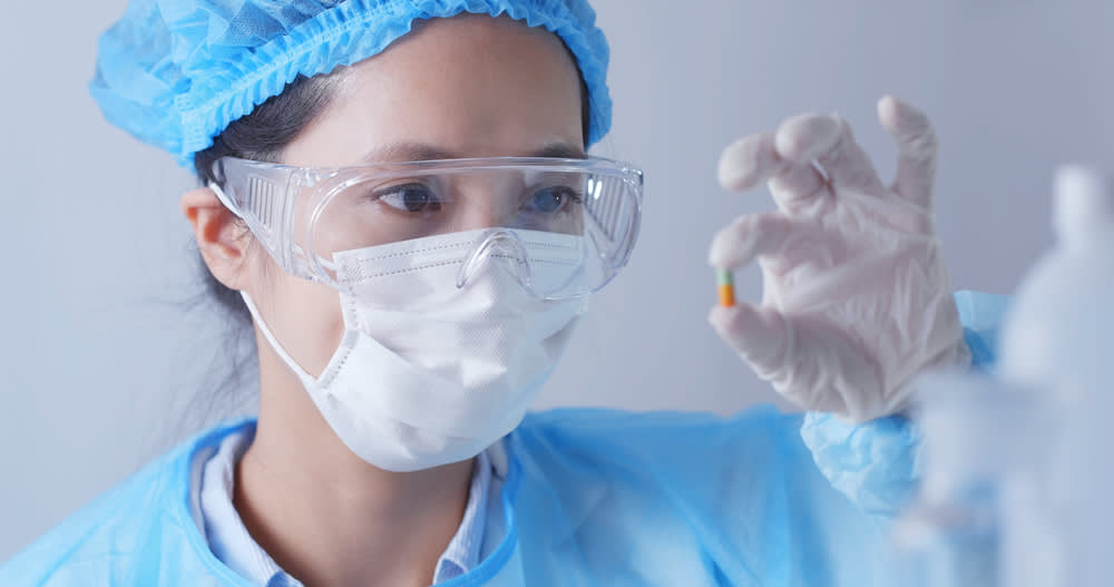 Forensic nurse inspecting an object