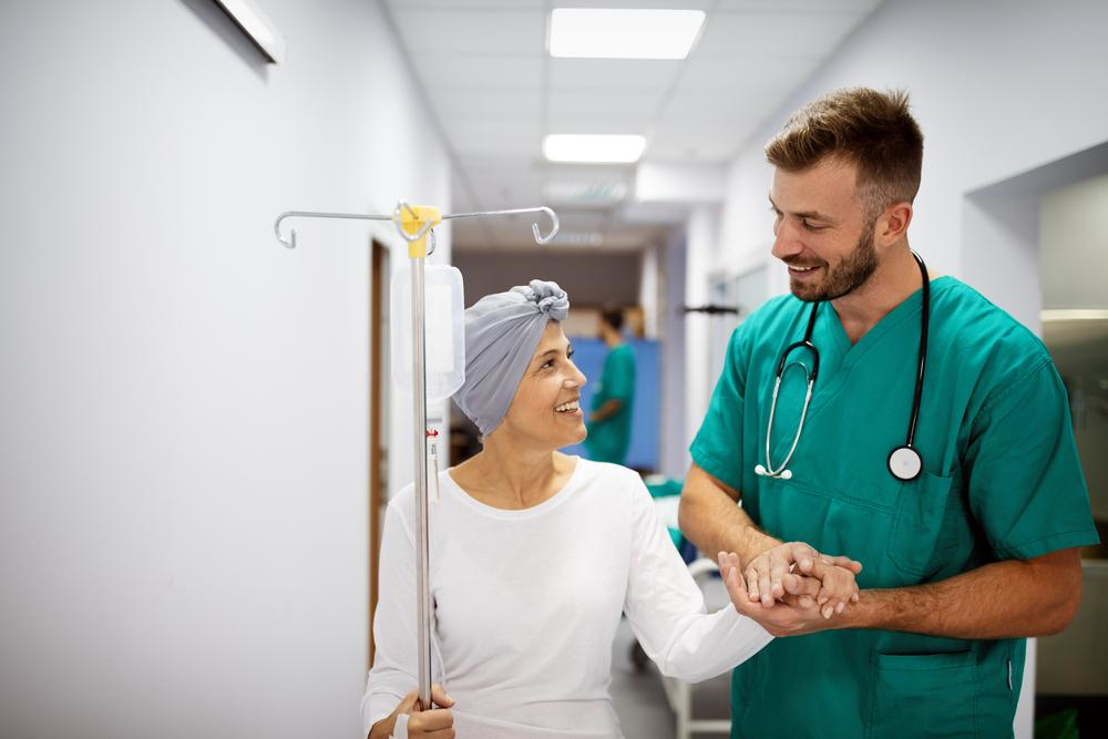 Oncology nurse escorting patient in the hospital