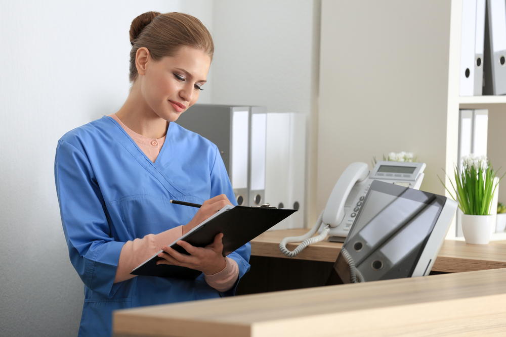 Nurse administrator standing with a clipboard