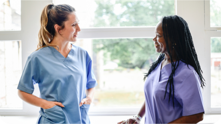 Two female nurses discuss bullying at work