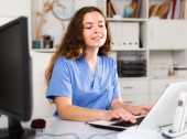 Nurse clinician working on a laptop