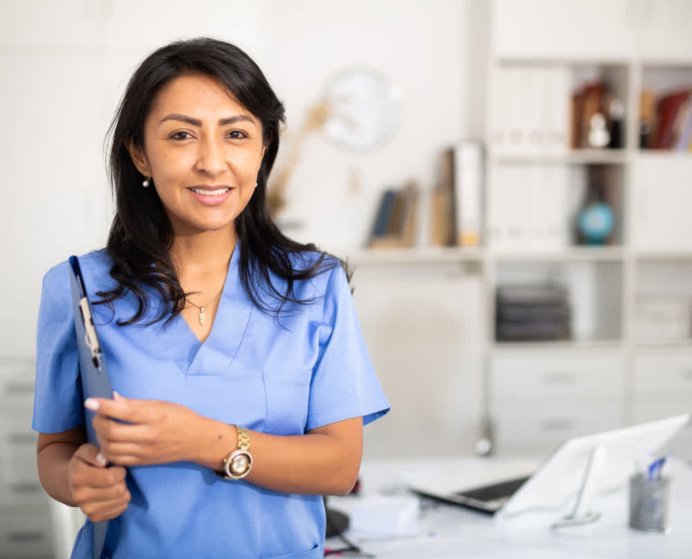Public health nurse standing in her office