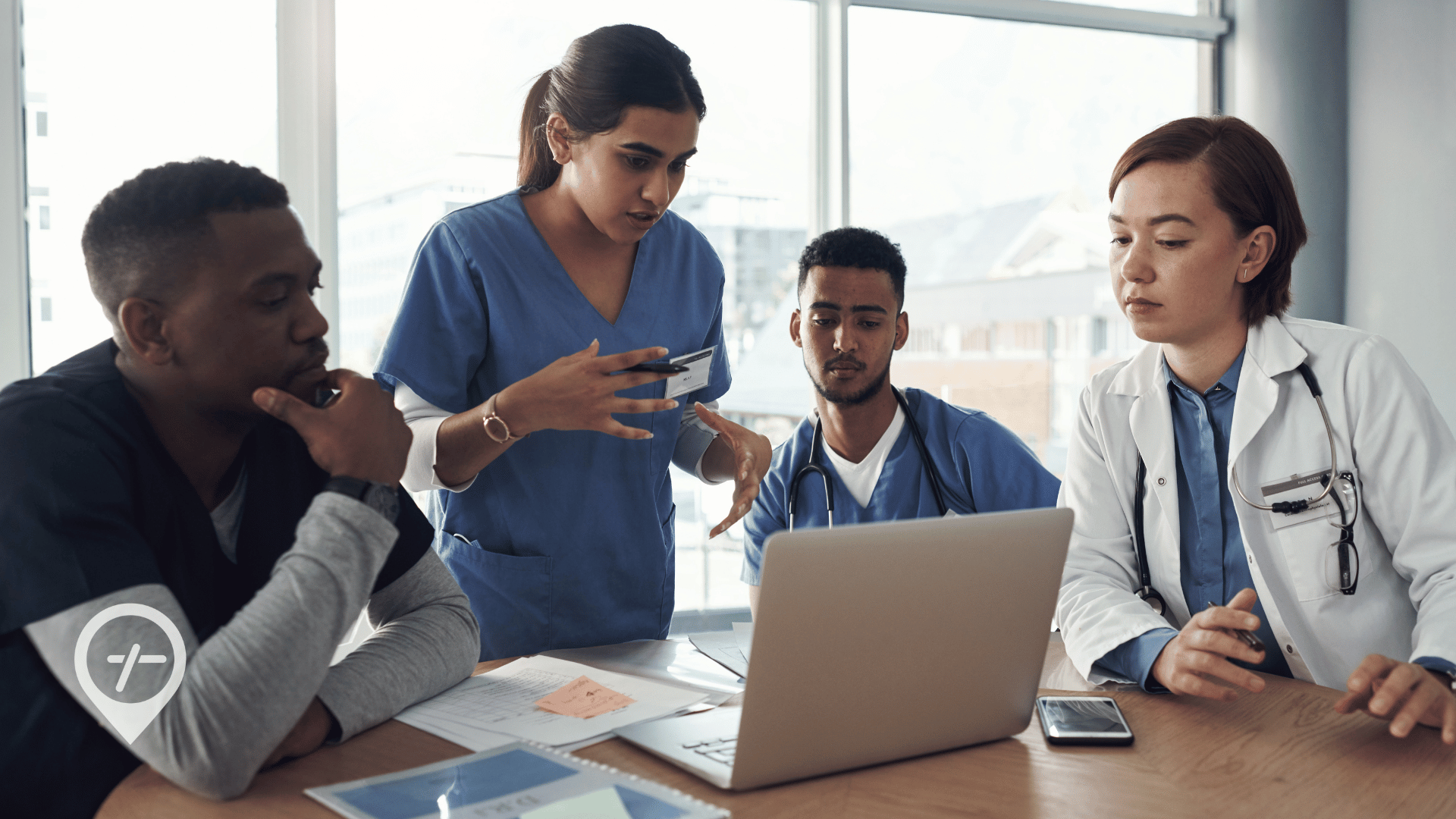 Nurses and a physician reviewing a digital scheduling system in a hospital, illustrating how nurse scheduling technology supports workforce culture, staffing efficiency, and care coordination.