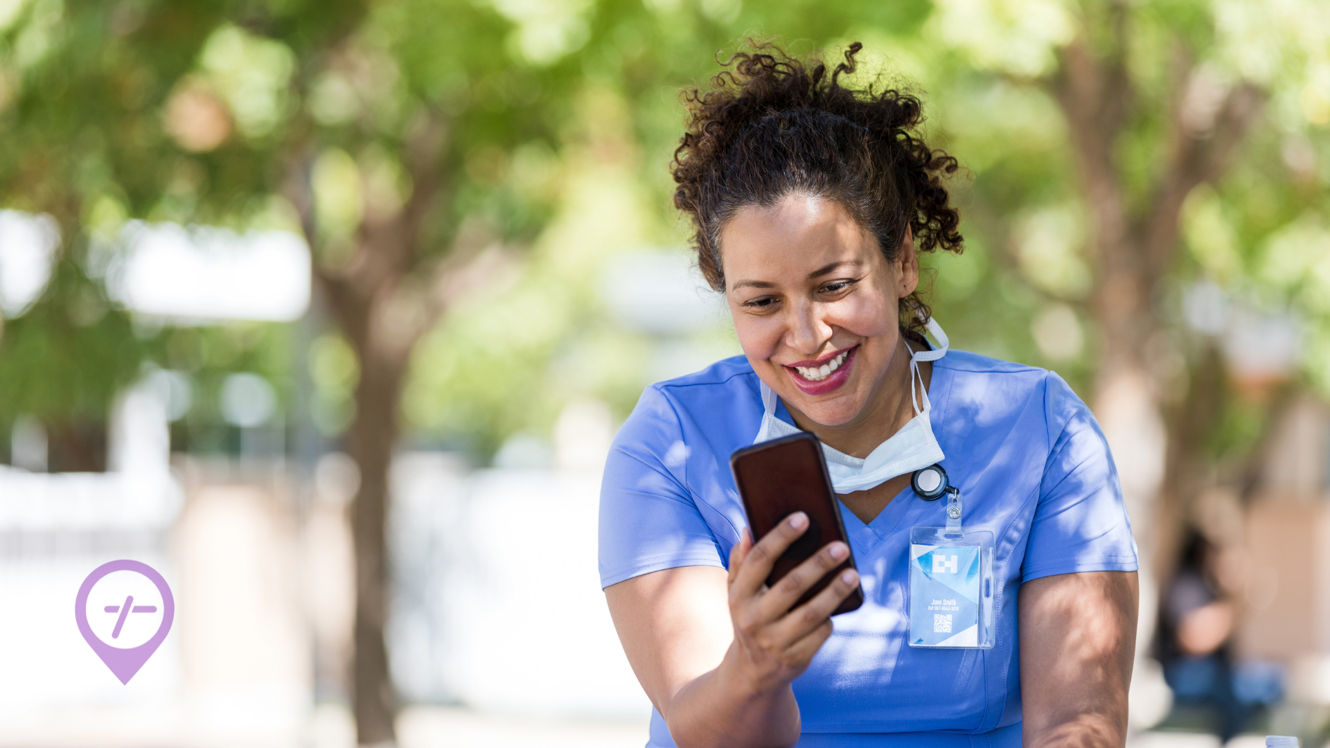 A nurse sitting outside scrolling through her phone looking for flexible nursing shifts.