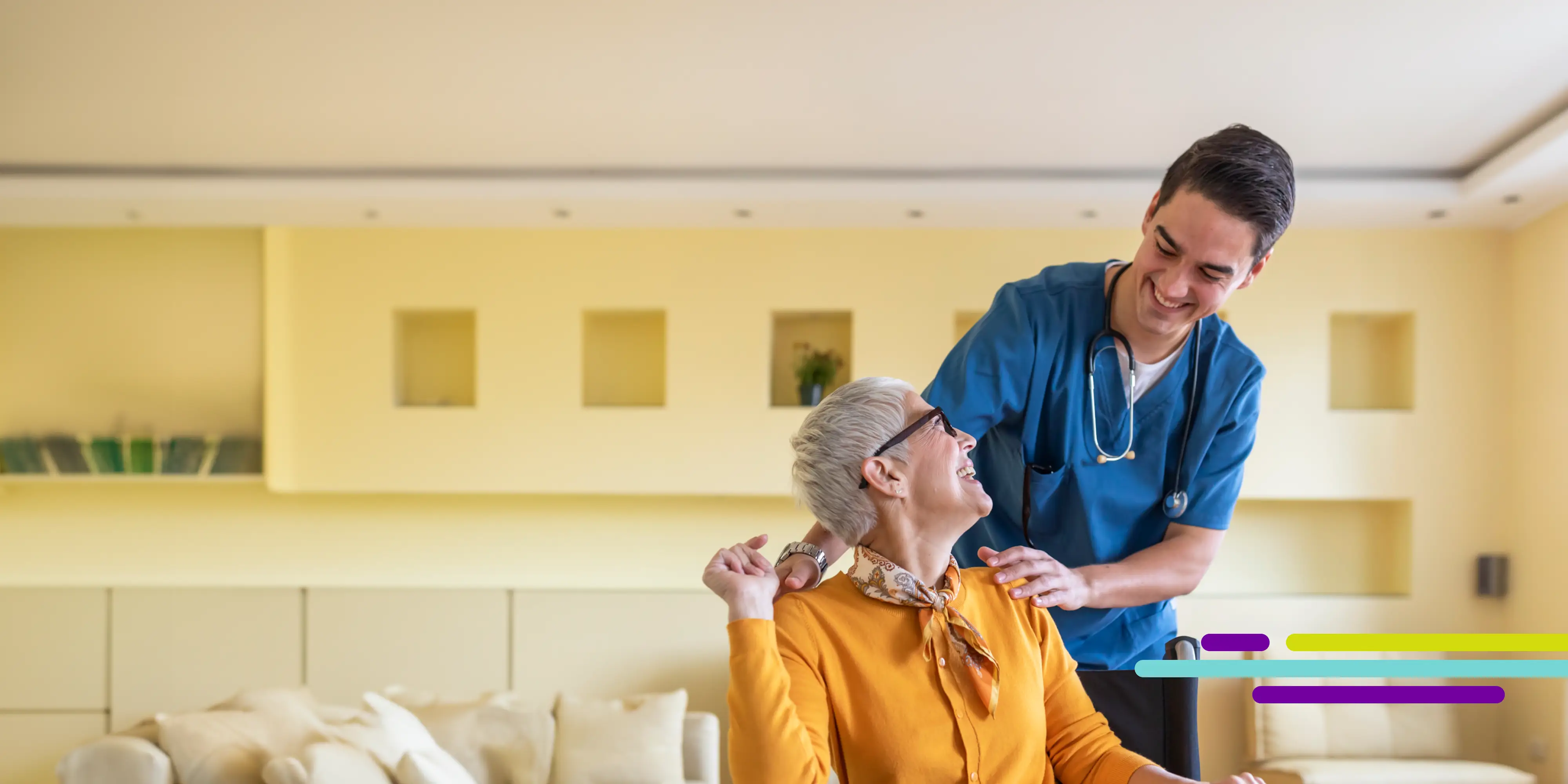 An in-home nurse places a sweater over an elderly woman's shoulders.