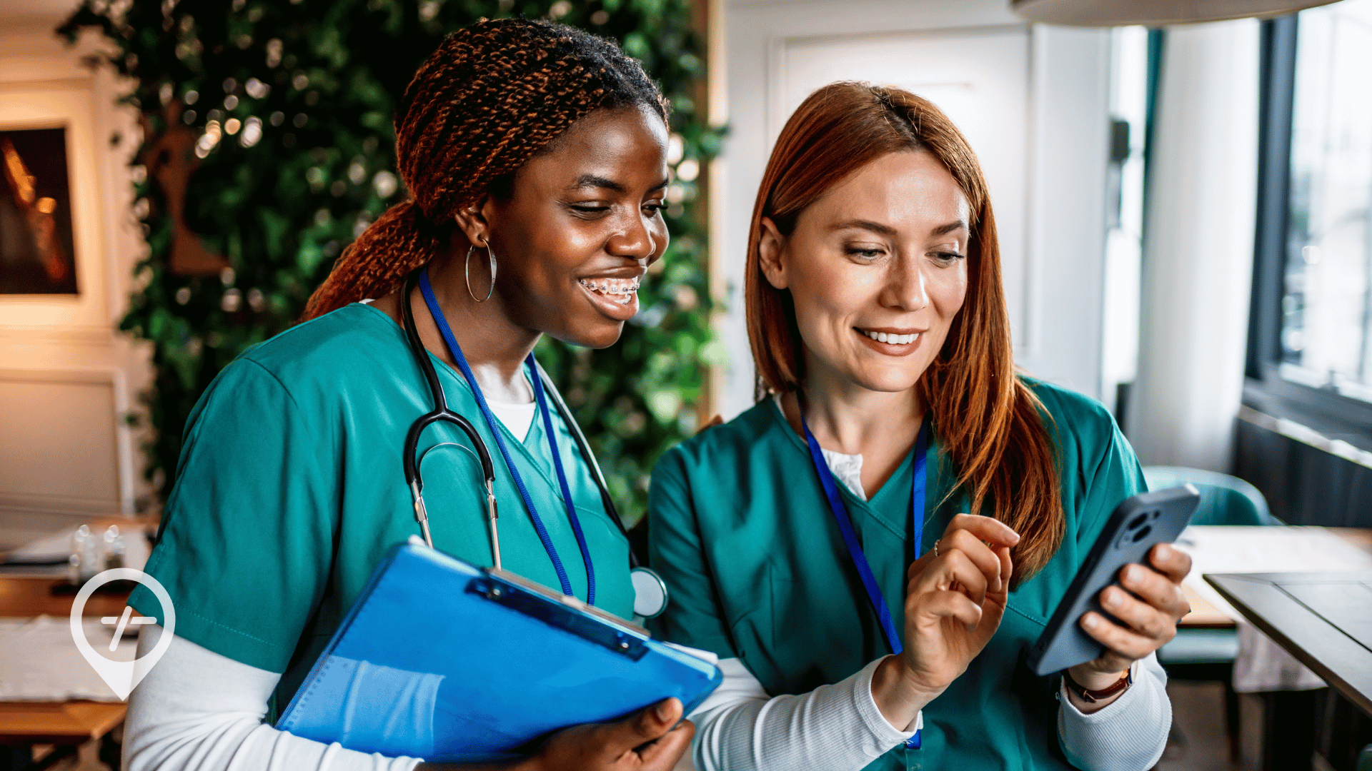 Two hospital nurses looking at self-scheduling opportunities on a nursing job app.
