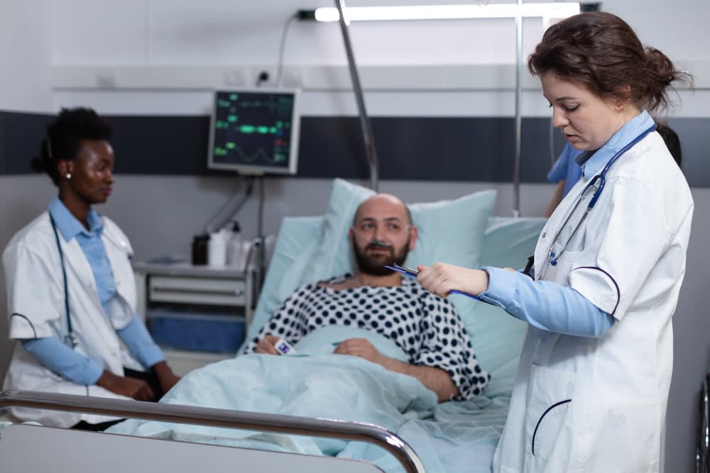 Acute care nurse monitoring a patient