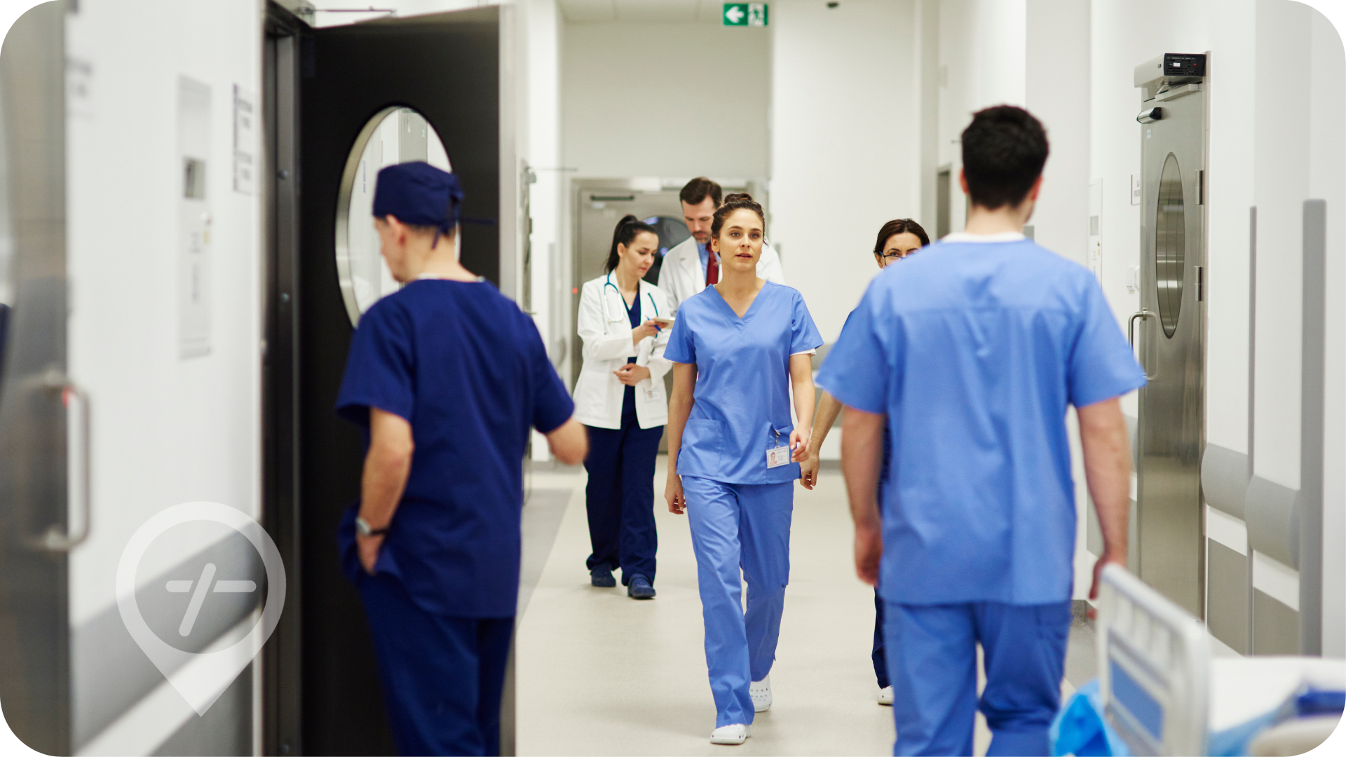 Healthcare float pool nurses walk through hospital hallway.