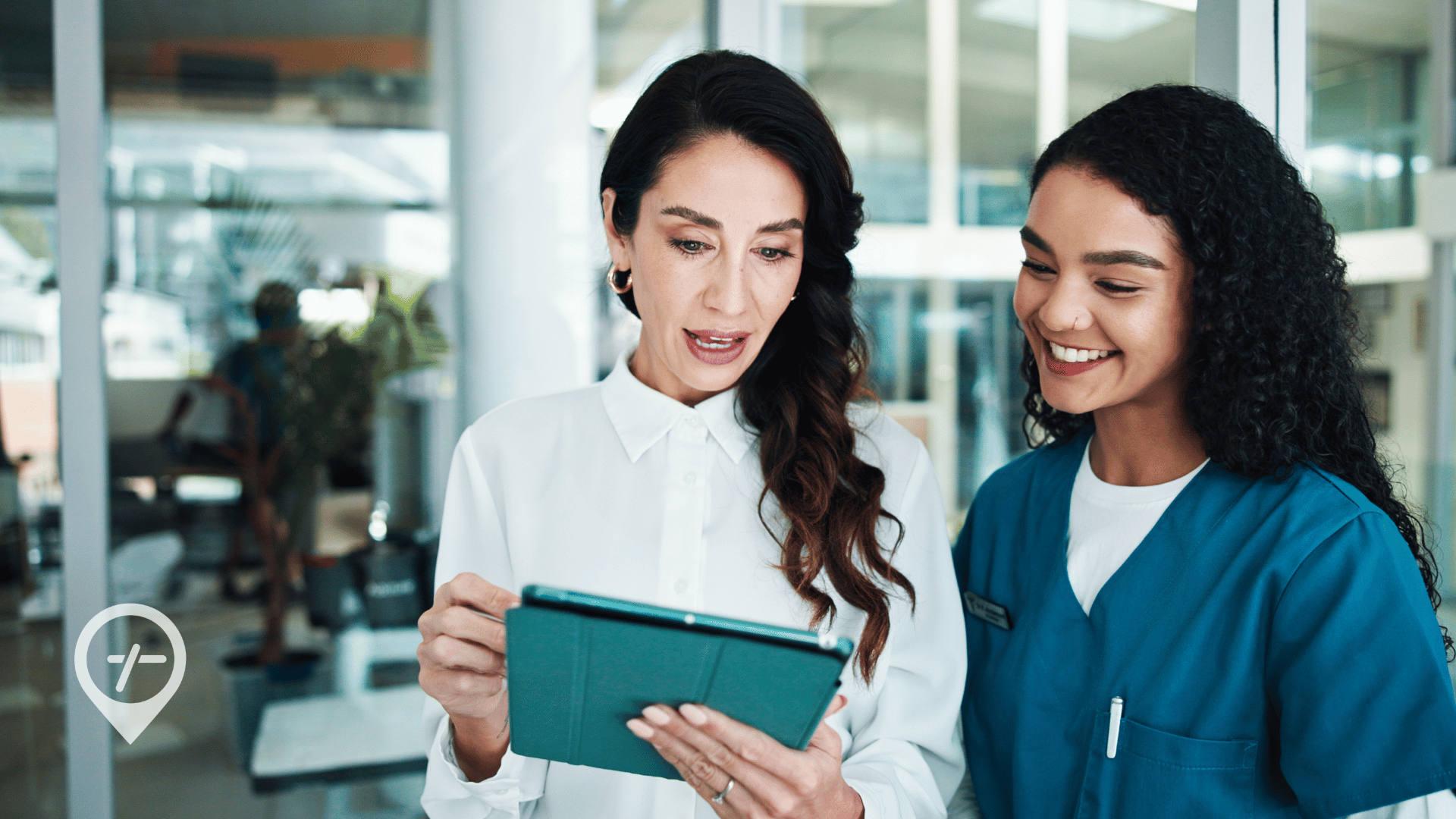 CNO and a nurse reviewing real-time hospital operations data while discussing workforce management and fluctuating patient census during a summer surge.