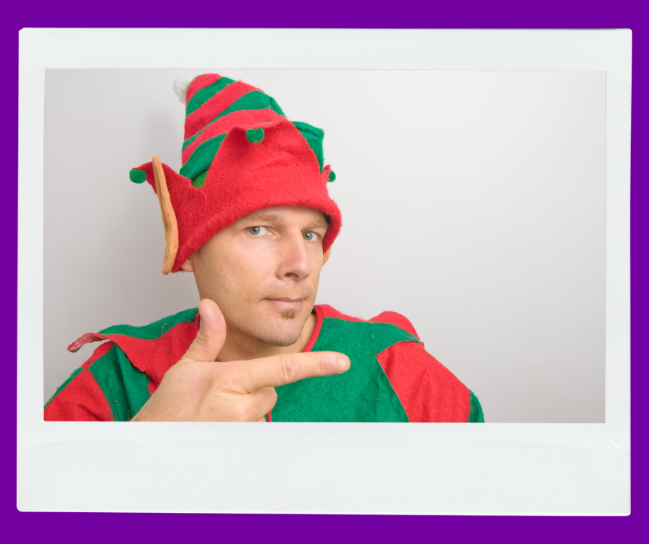 A man dressed up like an elf pointing his finger. 