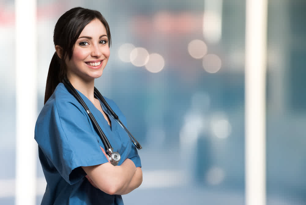 Medical assistant standing in a hospital corridor