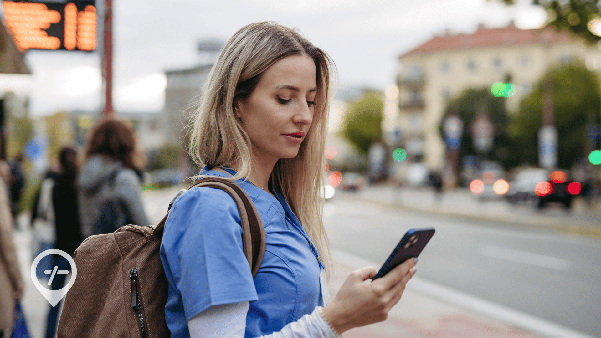 Nurse checking flexible nurse scheduling updates on her phone in a city environment.
