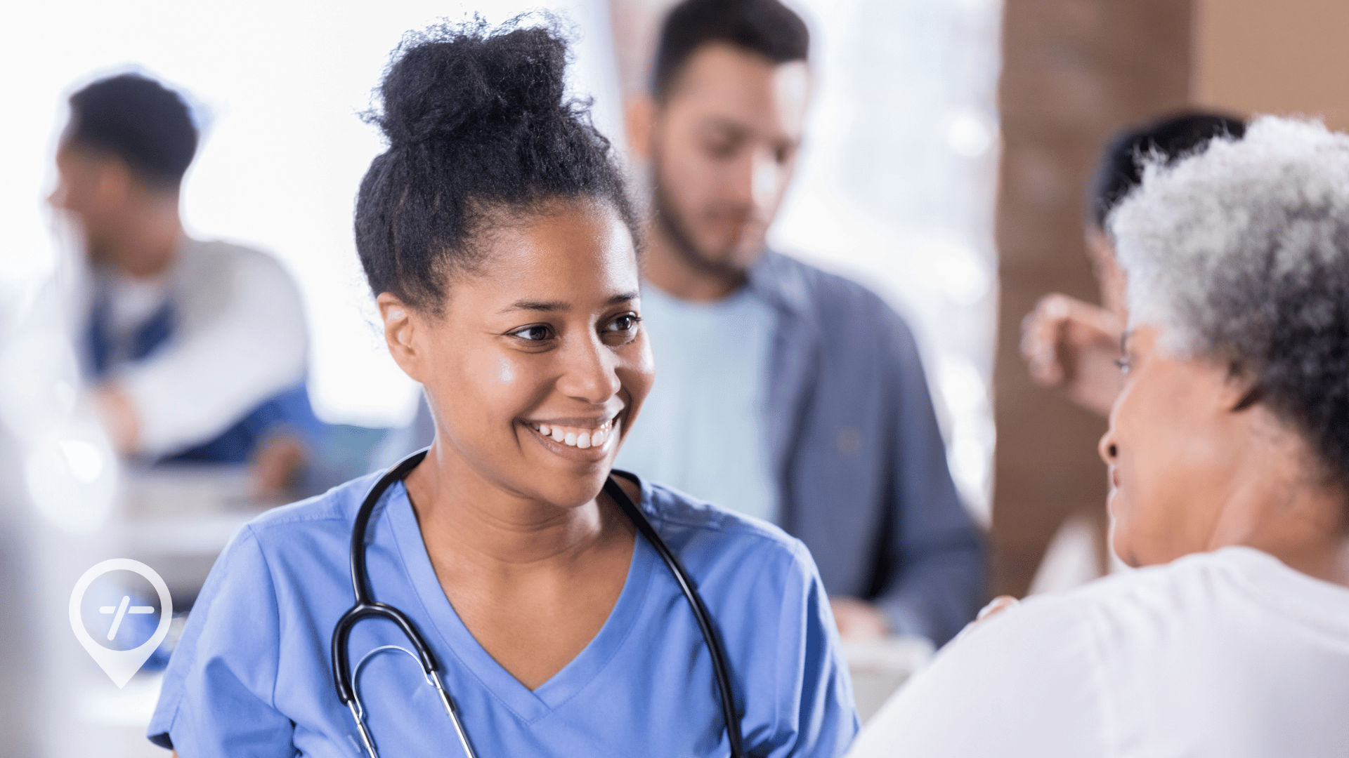 A community nurse smiles as she takes care of an elderly patient.