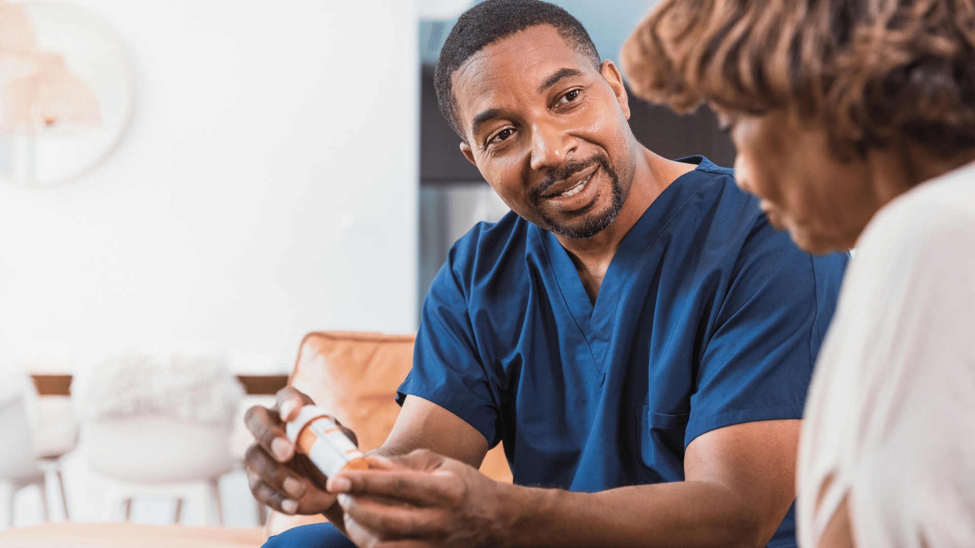 A photo of a nurse at a nursing home giving a resident medication instructions. 