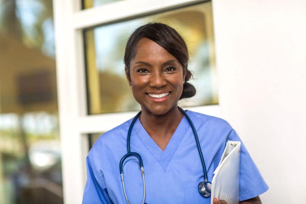 Happy nurse at an older age in the hospital