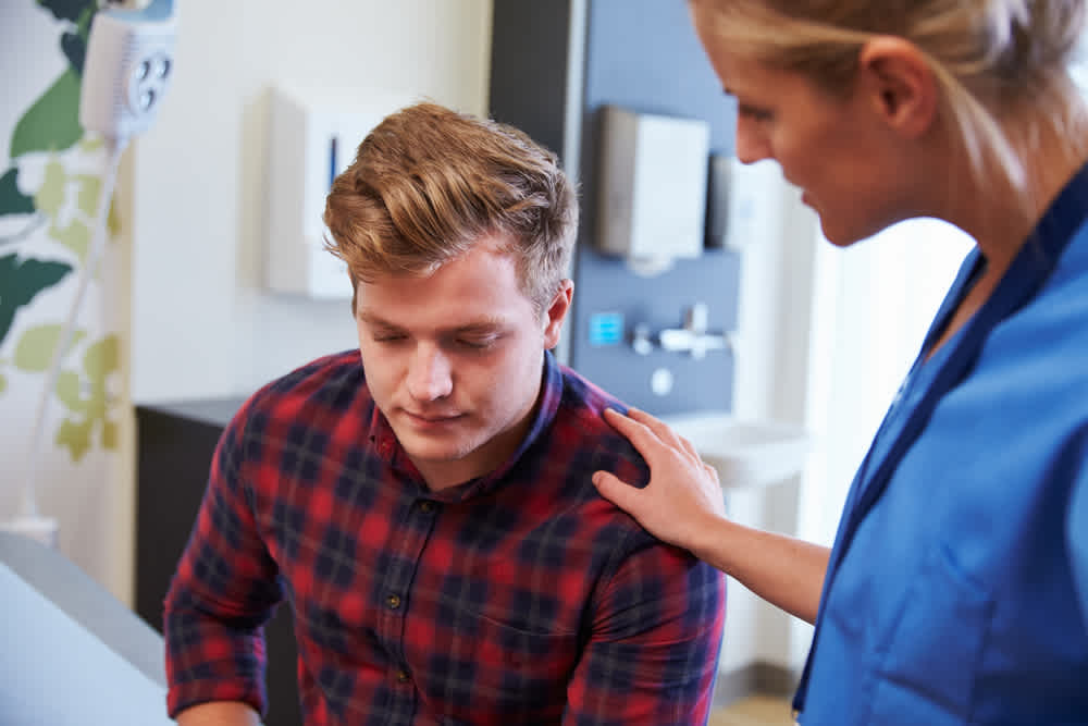 Mental health nurse talking to a patient