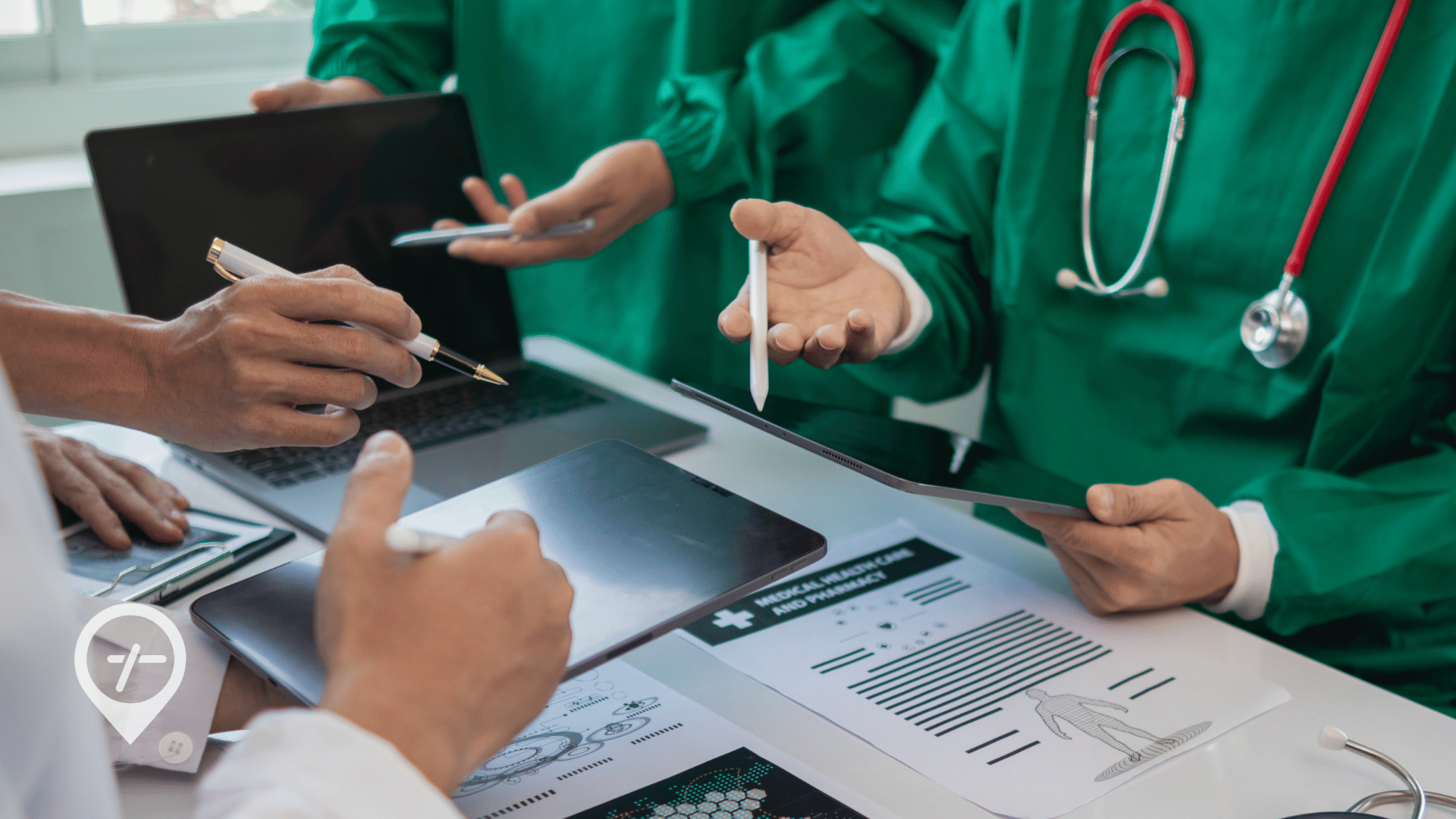 A group of nurses and doctors sitting at a desk reviewing healthcare workforce management RFPs.