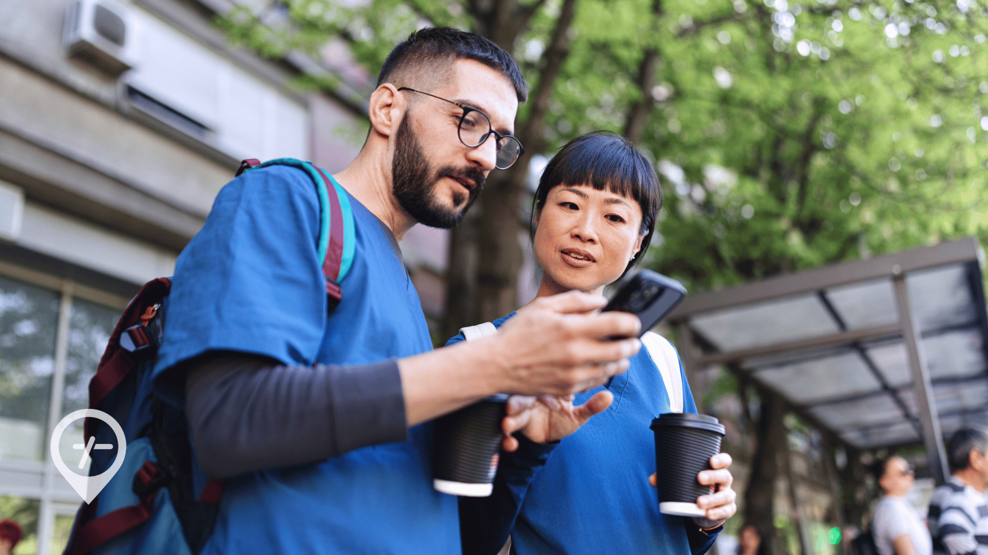 Male and female nurses outdoors using the best nursing jobs app for RNs to find flexible nursing shifts.