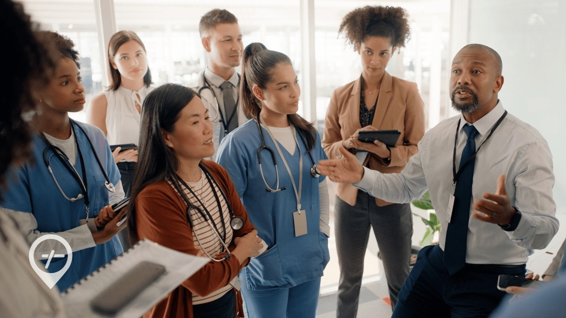 A health system executive talks with a team of clinicians about organizational culture.