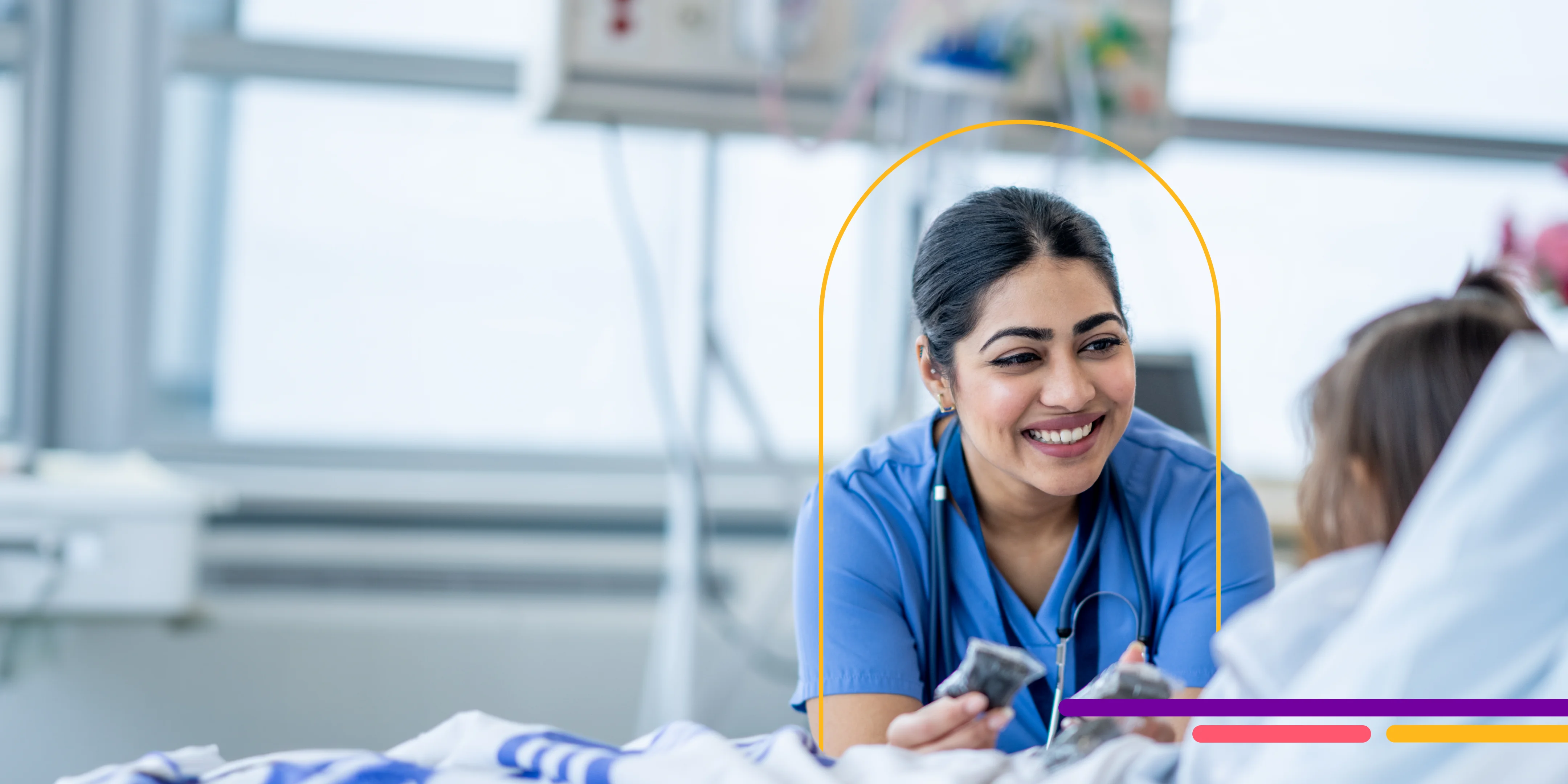 Nurse smiling at a young patient in bed.