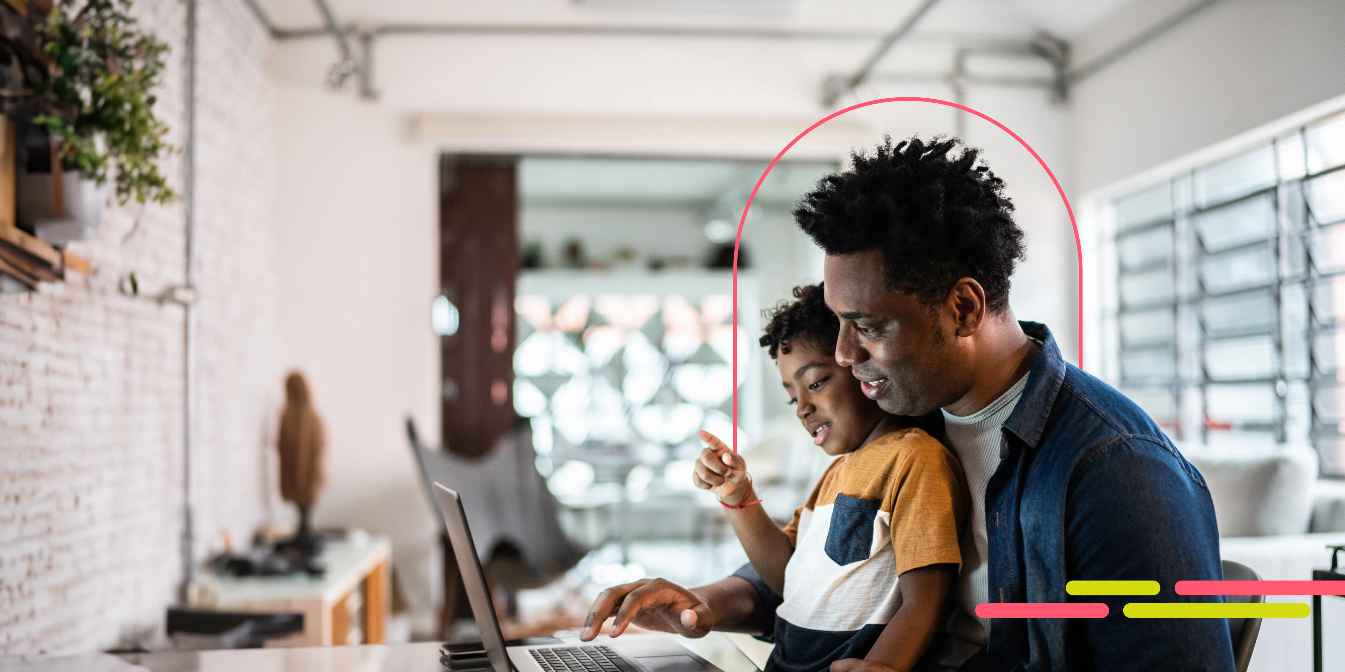 Man with his son at a computer.