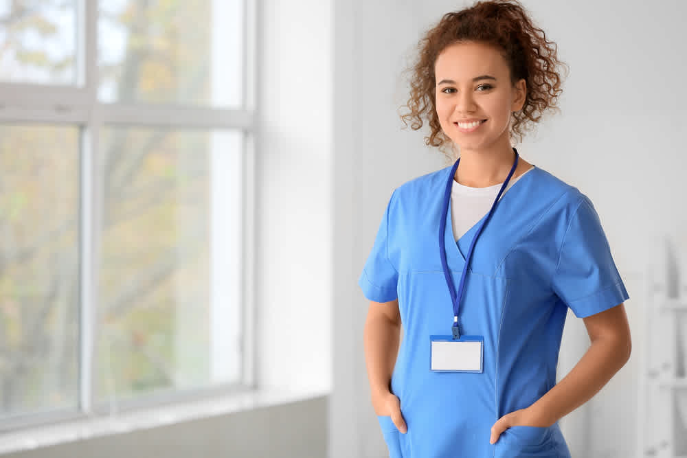 Triage nurse standing with her hands in her pockets