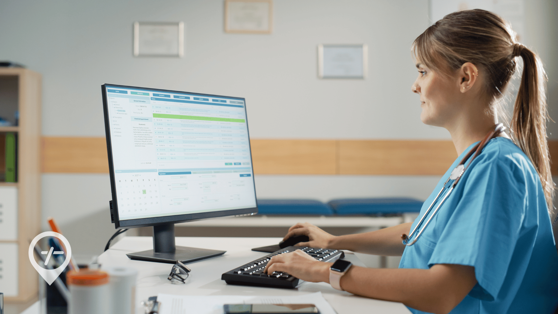 A nurse sitting in an office doing work on a computer.