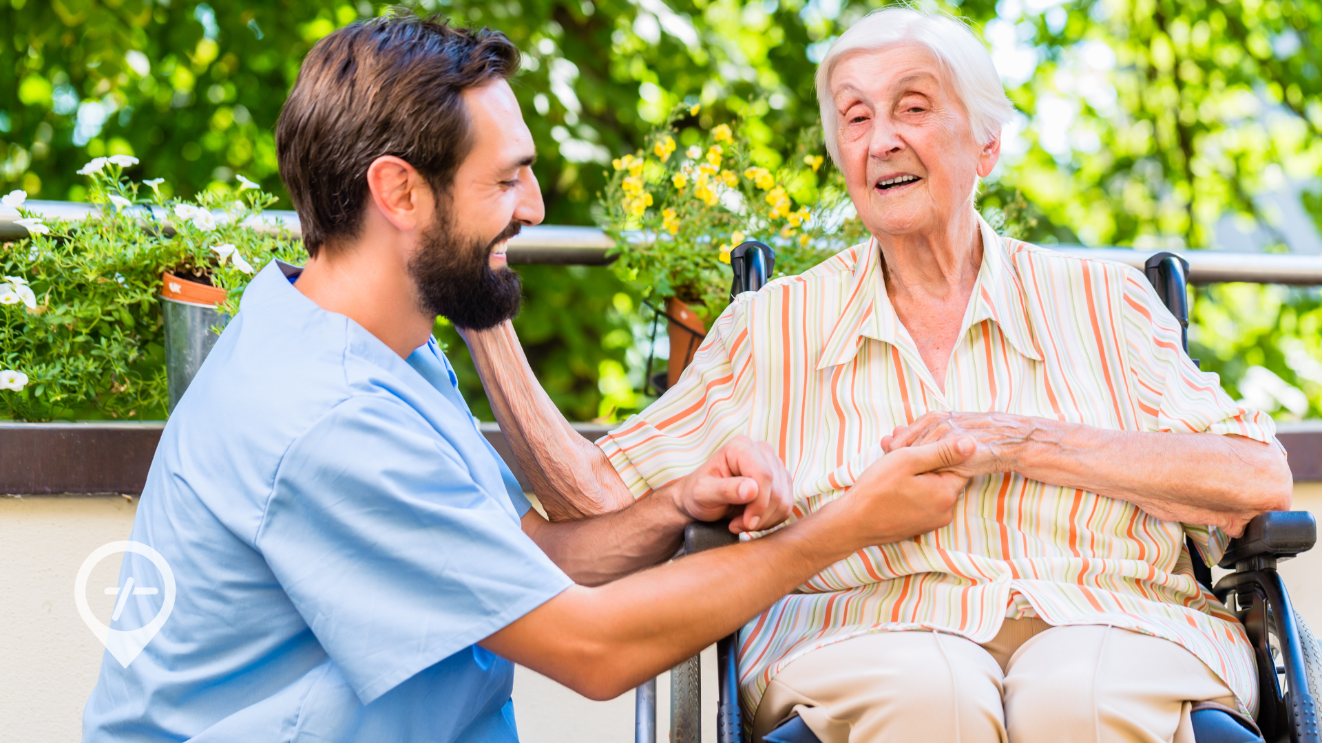 A young nurse smiles as he tends to an elderly patient in a wheelchair. 