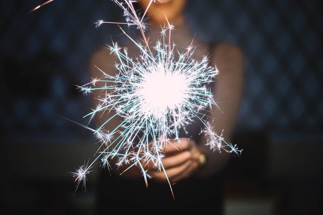 Sparkler hold with two hads by girl