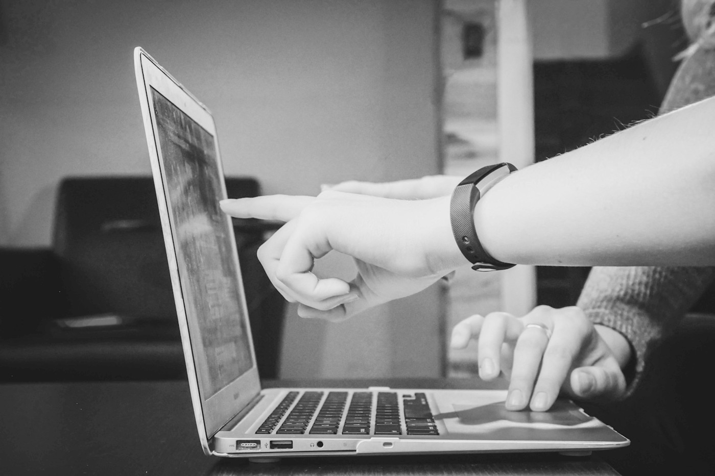 Hands pointing to a laptop