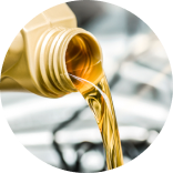  Oil being poured from a container into a vehicle engine.