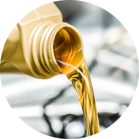 Oil being poured from a container into a vehicle engine.