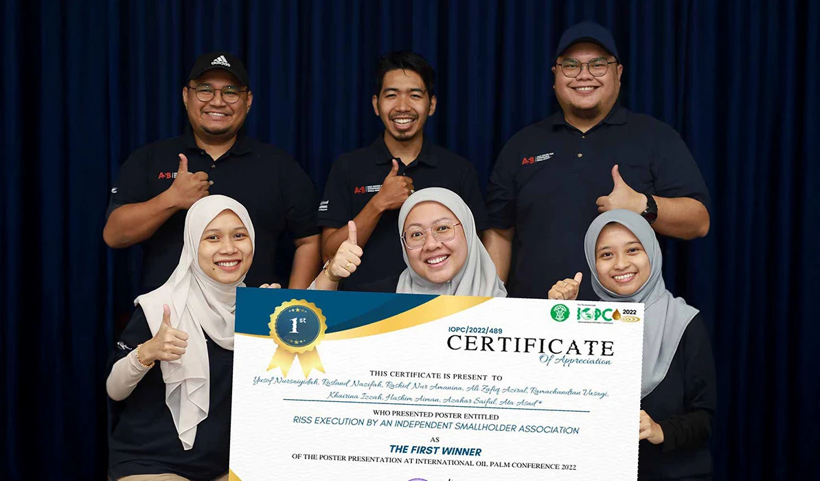 Group of smiling individuals holding a certificate of appreciation at an award ceremony, celebrating their achievement.