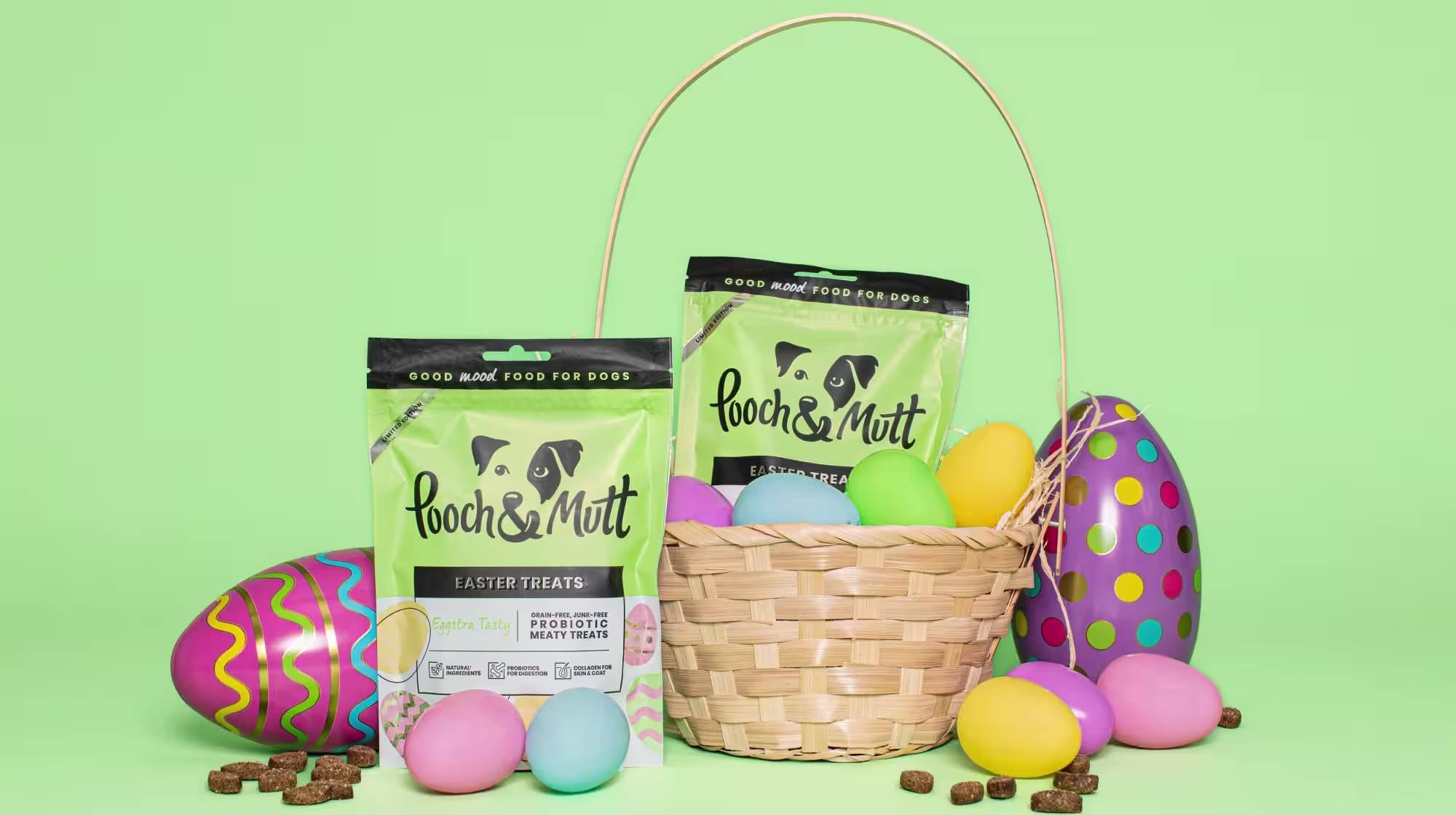 Easter treats and eggs with a basket on a green background