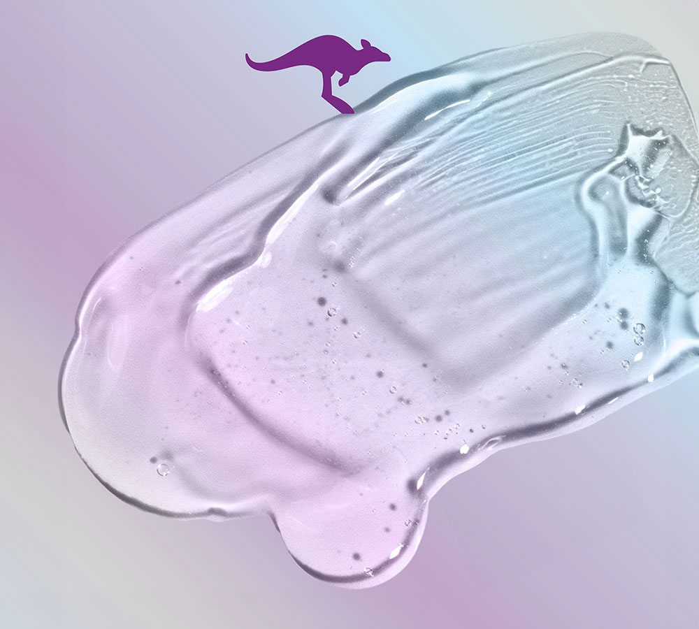 Una capa de gel transparente con burbujas, tonos rosa a azul, sobre superficie gris claro con canguro morado.