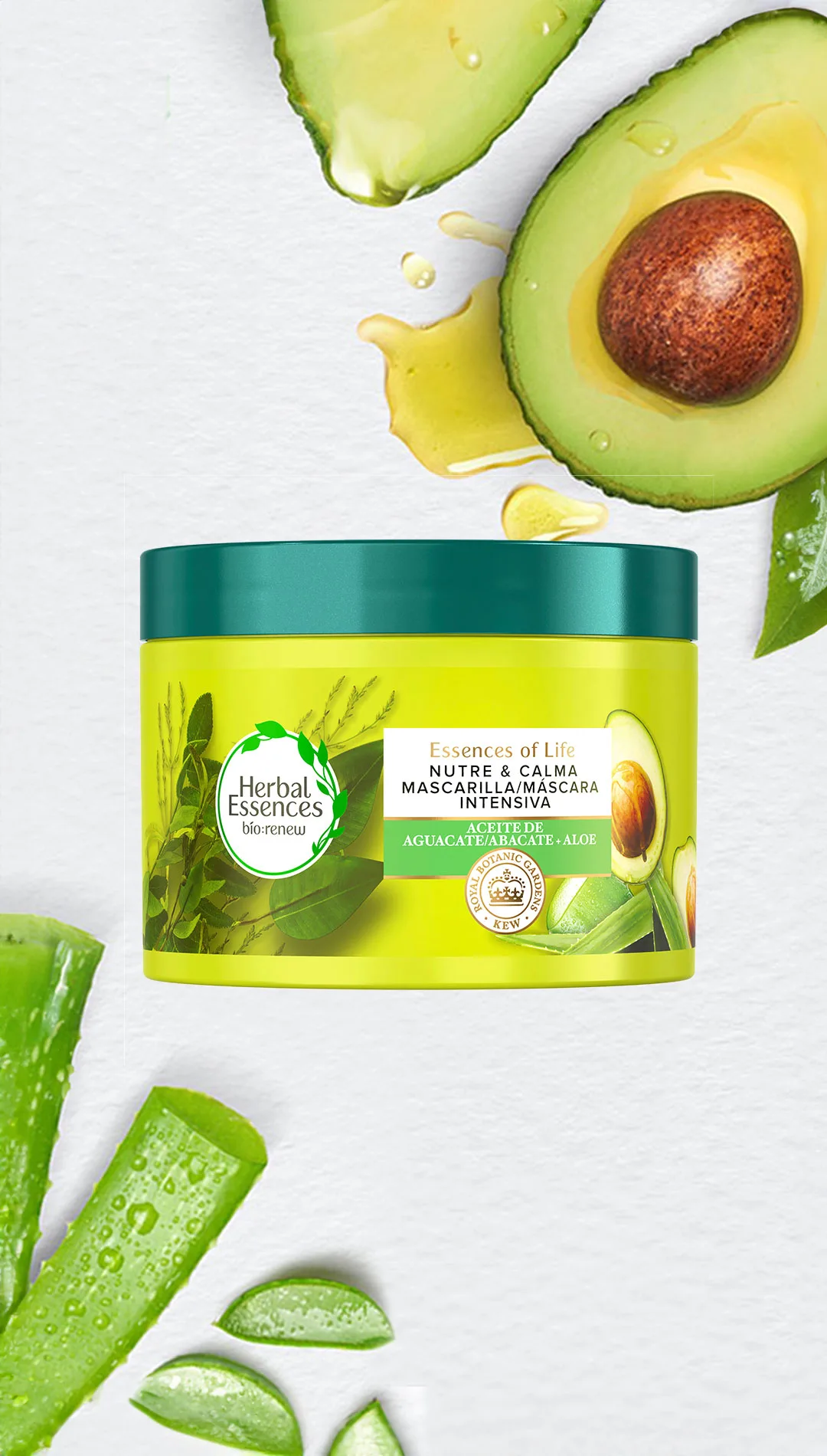 Tarro amarillo-verde Herbal Essences Nutre & Calma Mascarilla Intensiva, rodeado de rodajas de aguacate y hojas de aloe vera.