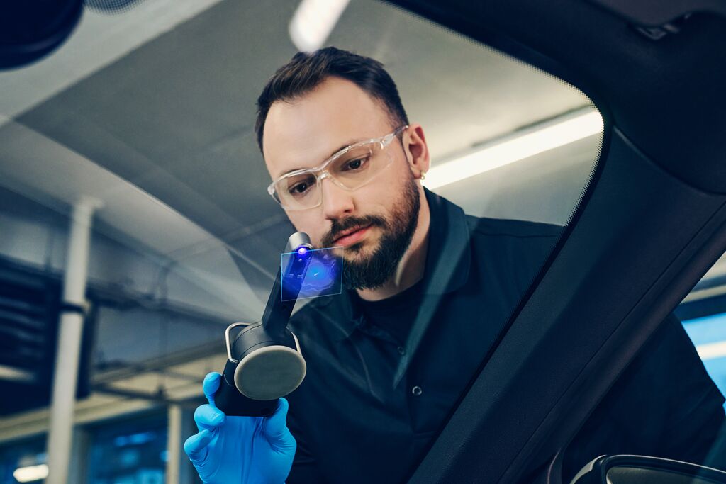 Man diagnosing a broken window