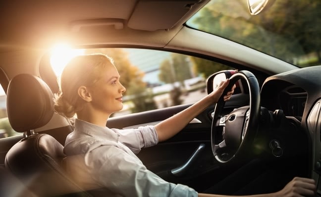 Side view of a woman driving a car