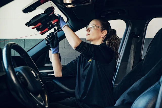 Technician removing a car windshield