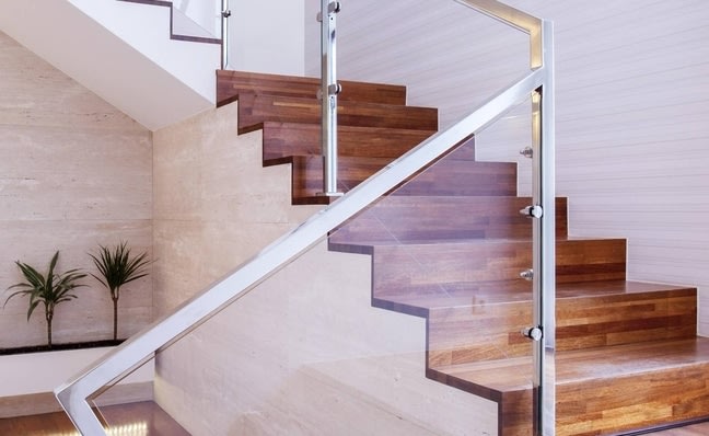 Wooden staircase with a glass railing