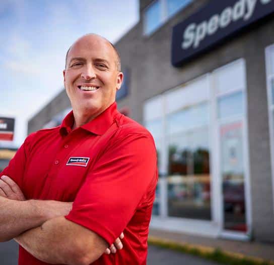 A person in front of a Speedy Glass center