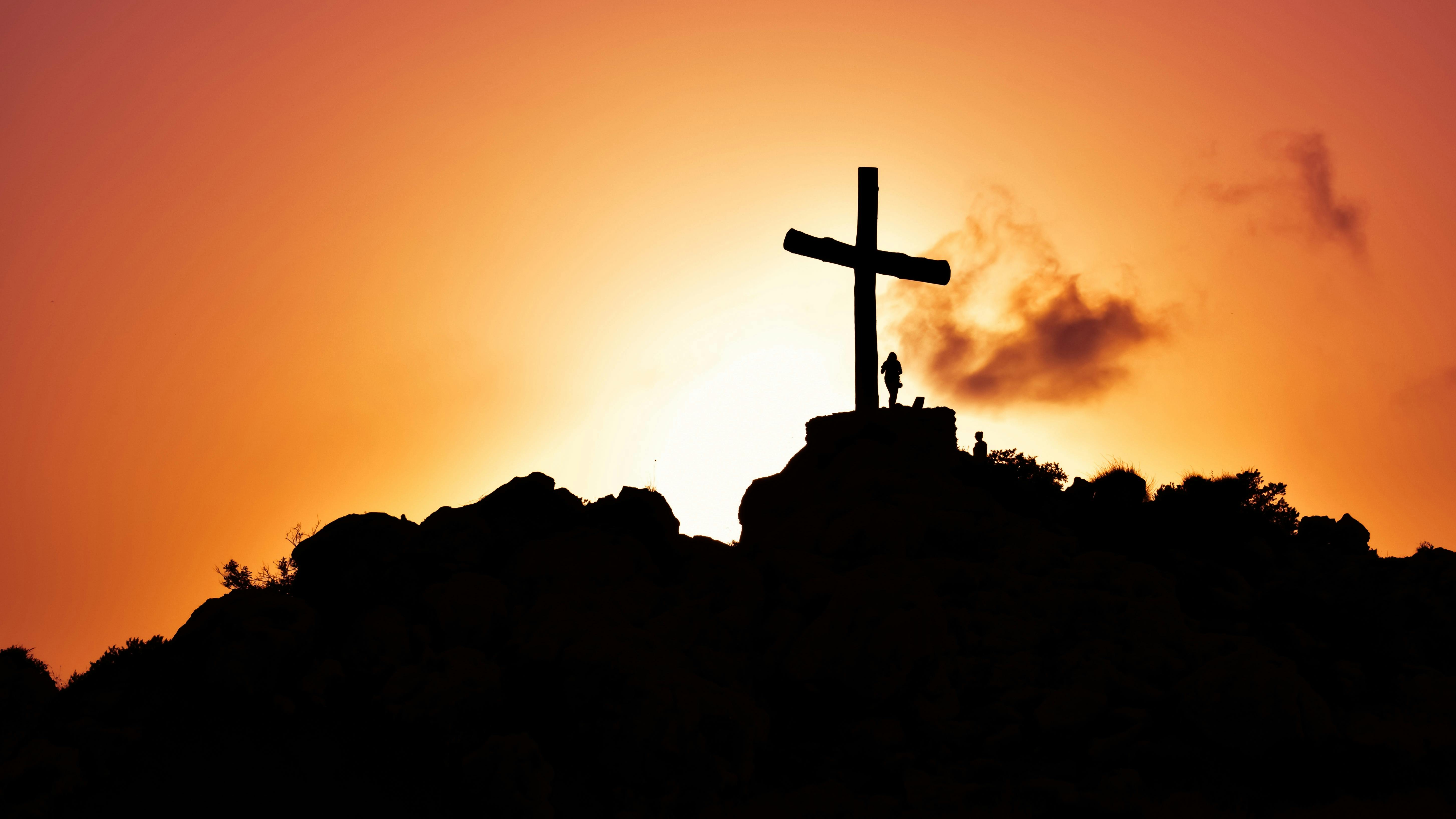 Free Human Standing Beside Crucifix Statue on Mountain Stock Photo