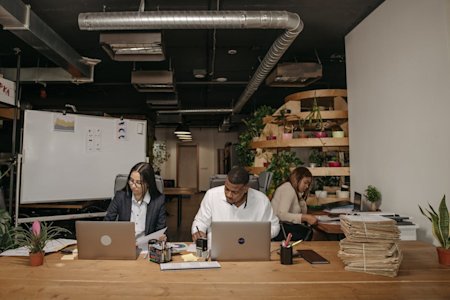 Coworkers in an office working on their computers.
