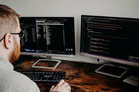 A person using a computer in an office.