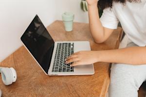 A person typing on a laptop.