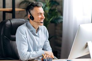 IT technician multitasking on multiple Mac and Windows computers, efficiently performing IT tasks